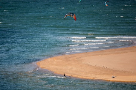 On the beach, white sand, sun loungers, beach towels