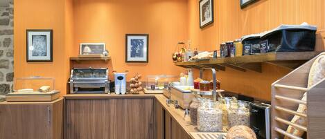 A breakfast buffet with various food items and condiments.