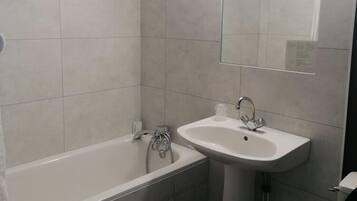 A bathroom with a bathtub, a sink, and a toilet.