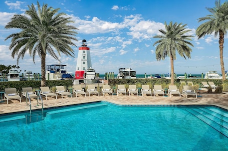 4 outdoor pools, pool umbrellas, sun loungers. Faro Blanco Resort Marathon Florida Keys, Curio by Hilton