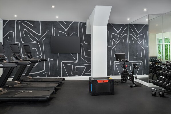 A gym with treadmills, a stationary bike, and a weight rack. - Faro Blanco Resort Marathon Florida Keys, Curio by Hilton (Marathon)