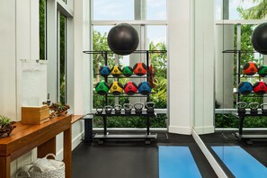 A gym with kettlebells, medicine balls, and a wooden bench. - Faro Blanco Resort Marathon Florida Keys, Curio by Hilton (Marathon)