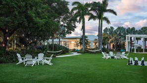 A well-maintained lawn with outdoor seating and a hammock. - Faro Blanco Resort Marathon Florida Keys, Curio by Hilton (Marathon)