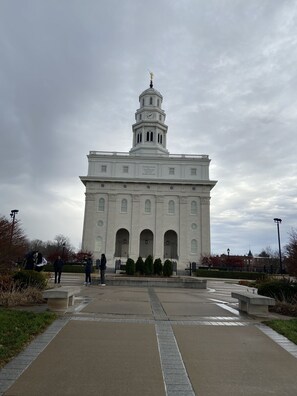 A large white building with a clock tower and arched windows.