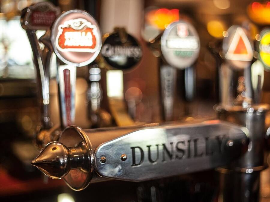 A row of beer taps with the brand name "DUNSILL" prominently displayed.