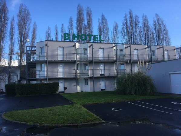 A multi-story hotel building with a sign reading "B HOTEL".