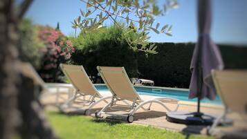 Seasonal outdoor pool, open 9:30 AM to 8:30 PM, pool umbrellas