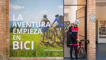 A cycling-themed advertisement for Fuerte Grazalema, featuring a cyclist and a bicycle.