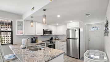 Fridge, microwave, coffee/tea maker, cookware/dishes/utensils