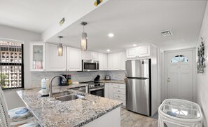 Fridge, microwave, coffee/tea maker, cookware/dishes/utensils