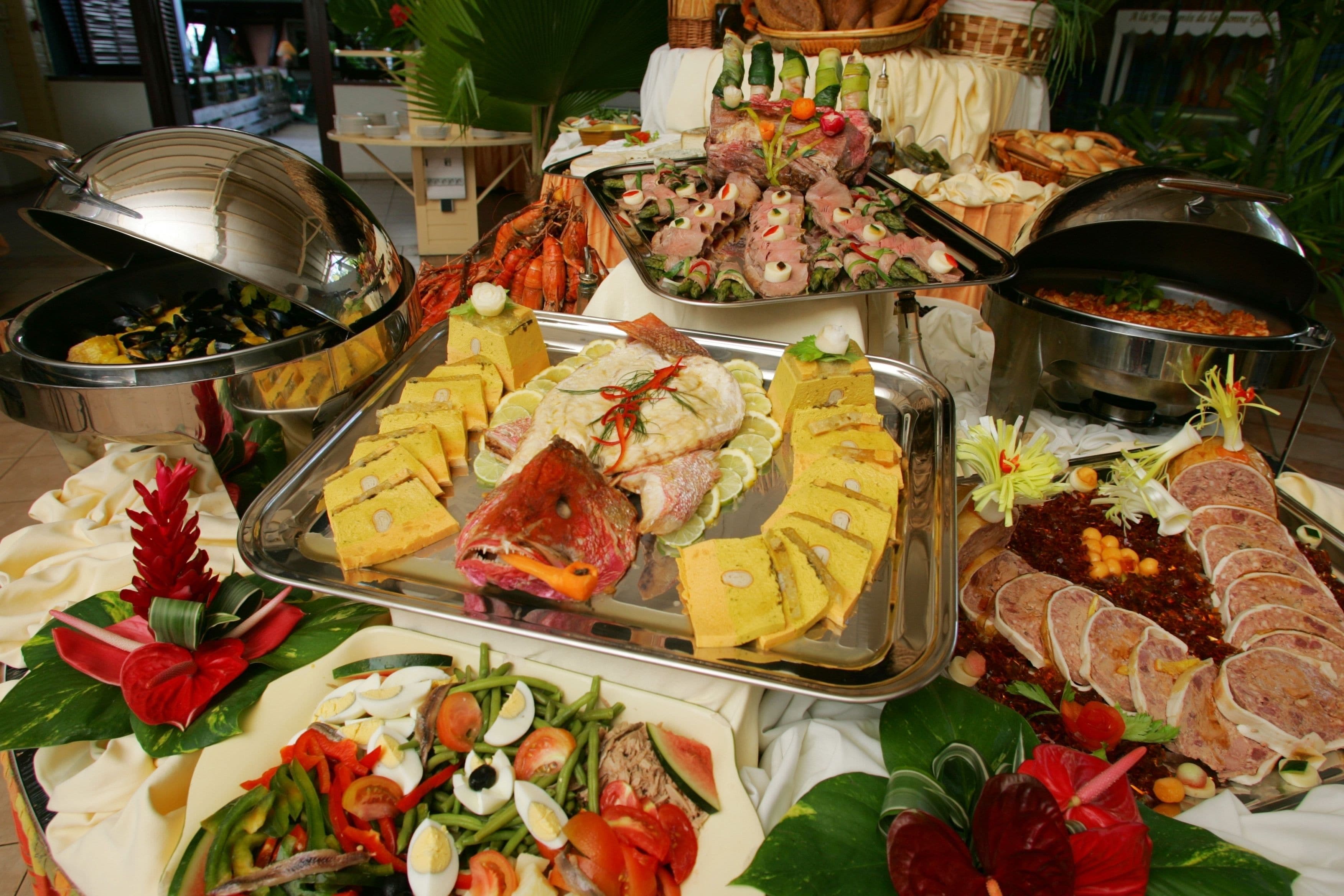 A buffet with various dishes including seafood, meats, and salads.