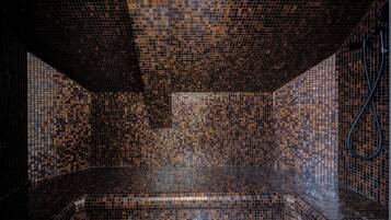 Experience the unique mosaic tile design and bench in this stylish room.