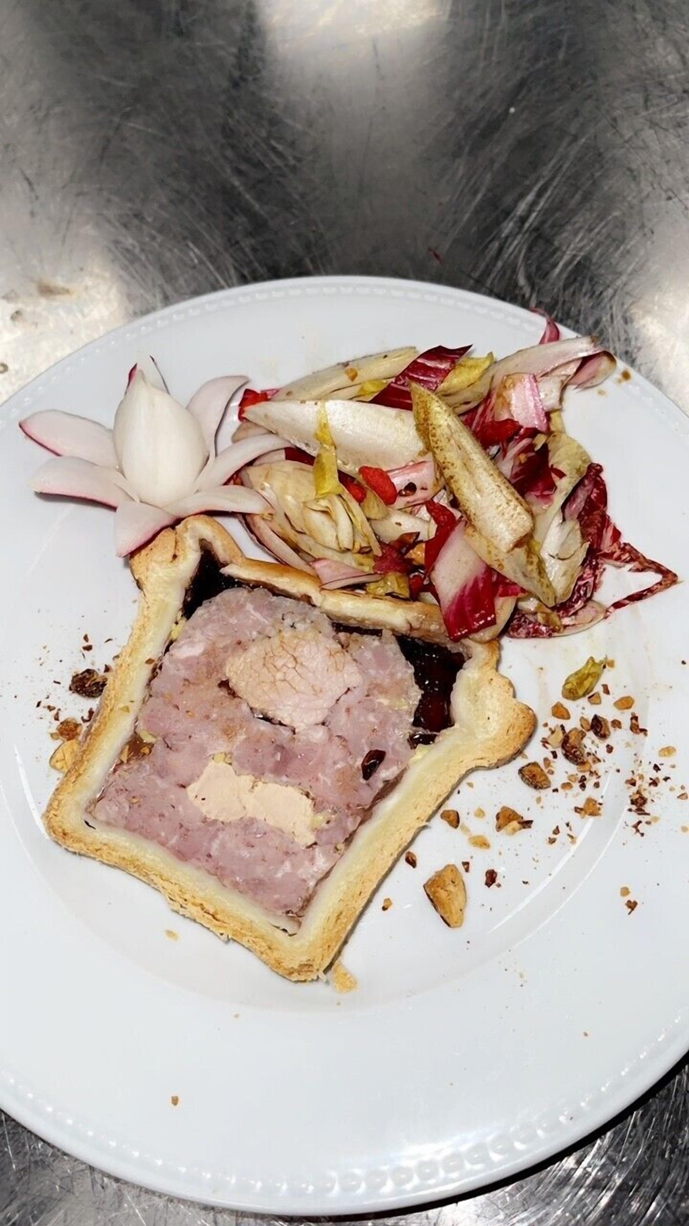A plate with a meat dish and a side salad.
