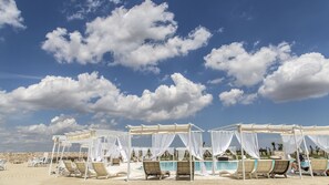 A beachside resort with white canopies over seating areas and a pool. - Hotel Relais Antica Masseria (Conversano)