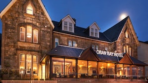 A large stone building with a prominent sign reading "OBAN BAY HOTEL".