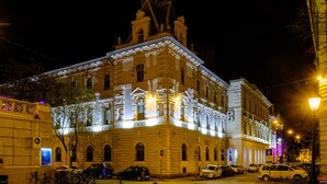 A historic building with classical architecture, featuring a prominent tower and arched windows. - Tisza Hotel (Szeged)