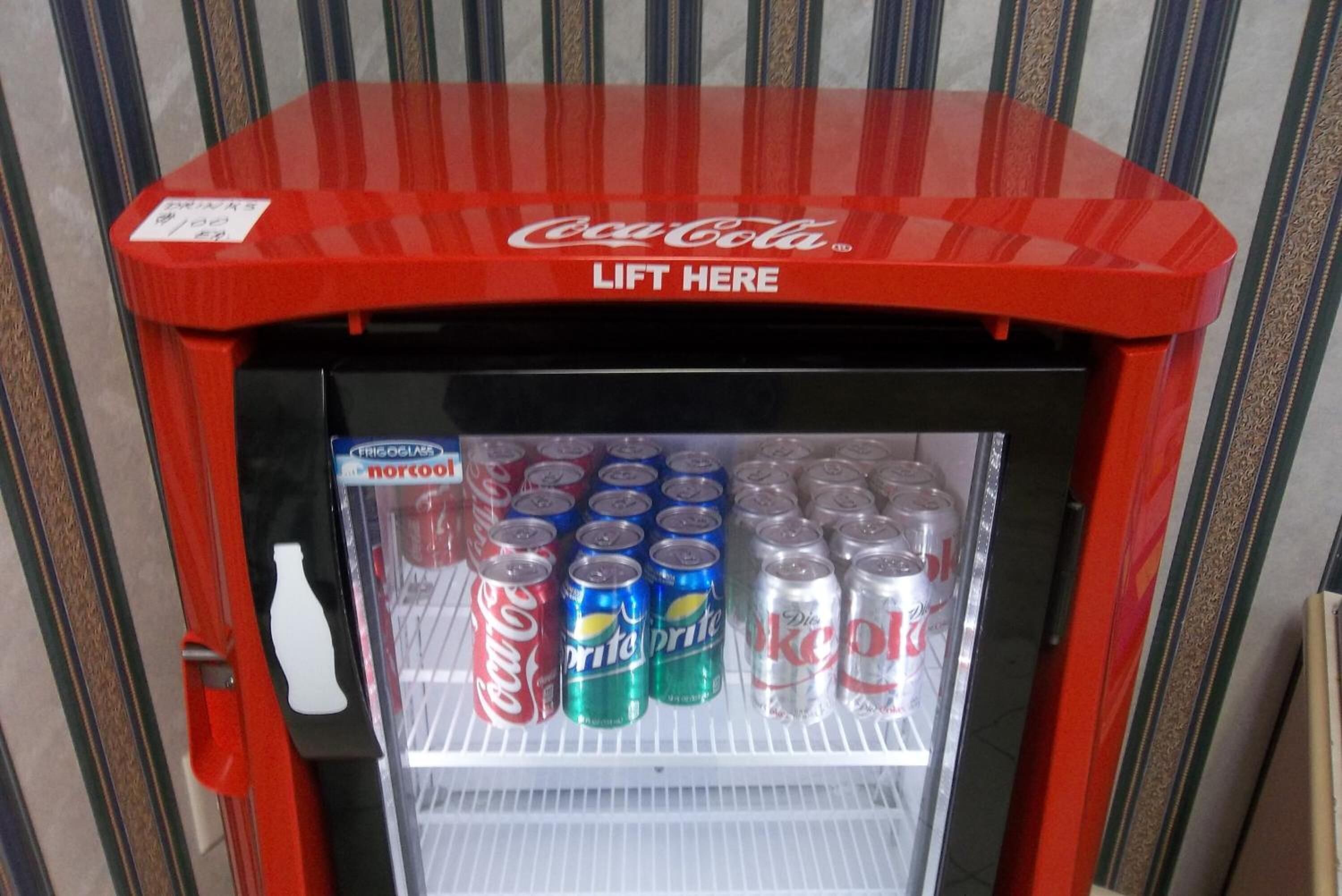 A Coca-Cola vending machine with multiple beverage options including Diet Coke, Sprite, and Fanta.