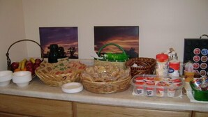 A kitchen counter with various food items and kitchenware. - Douglas Inn & Suites (Blue Ridge)