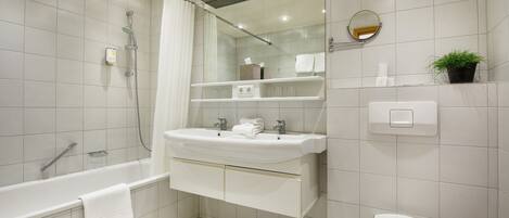 A modern bathroom with a bathtub, sink, and toilet.