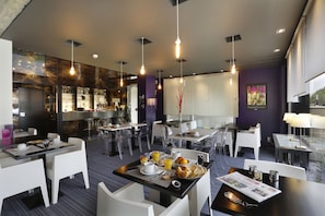 Enjoy a self-service dining experience in our contemporary dining area, featuring a mix of seating and a selection of food and beverages.