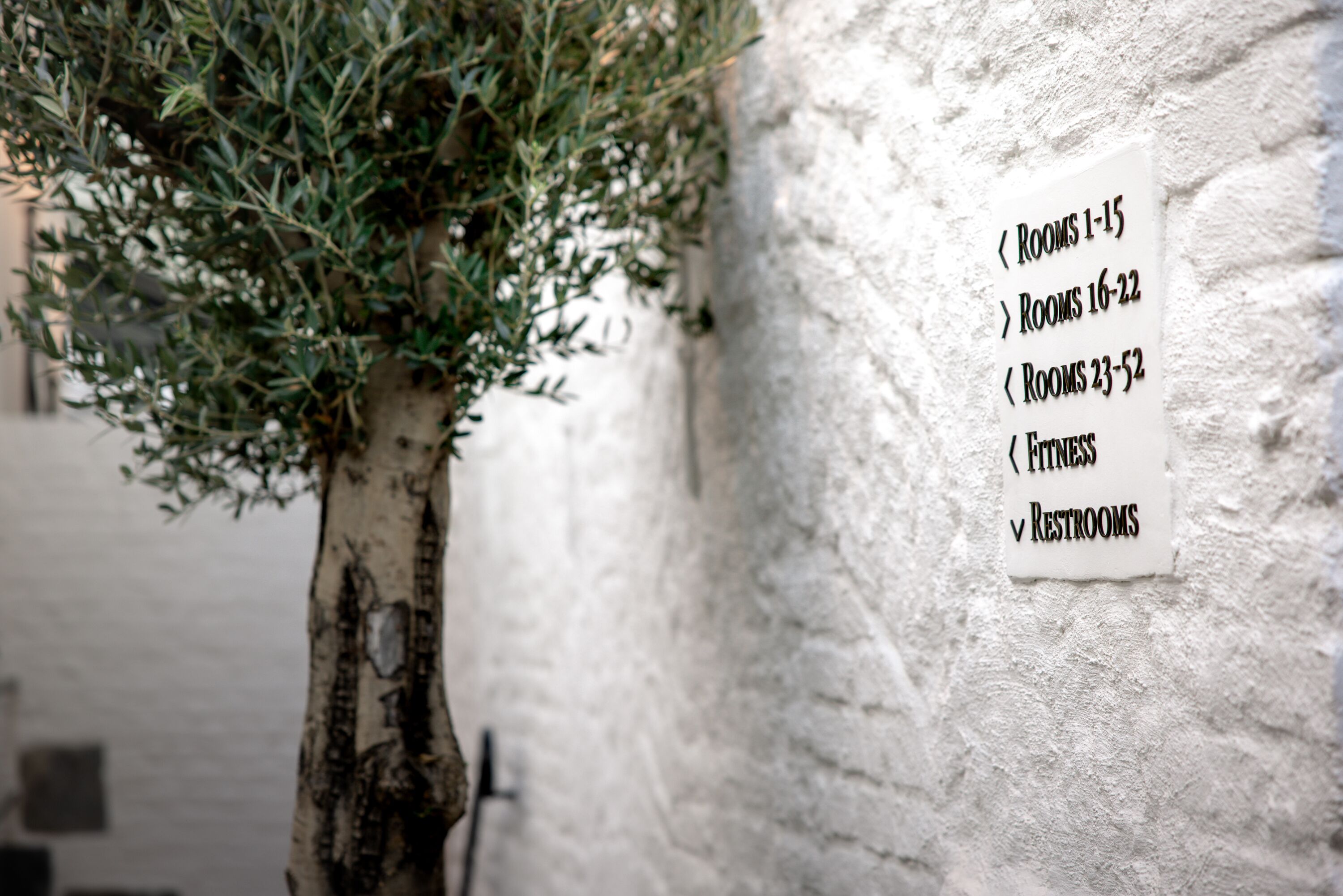 A wall sign with room numbers and amenities.