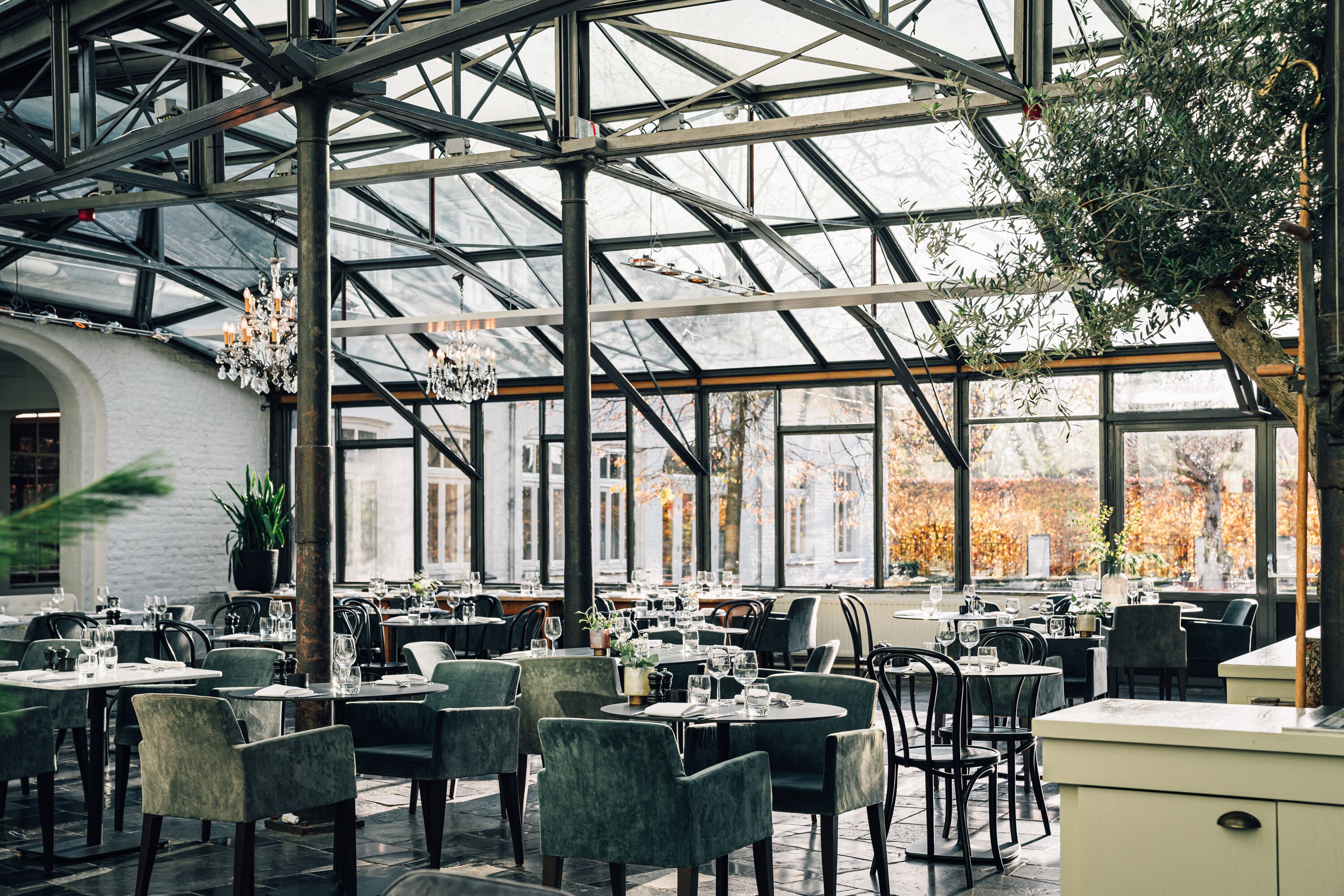 Ein Restaurant mit Glasdecke und gedeckten Tischen.