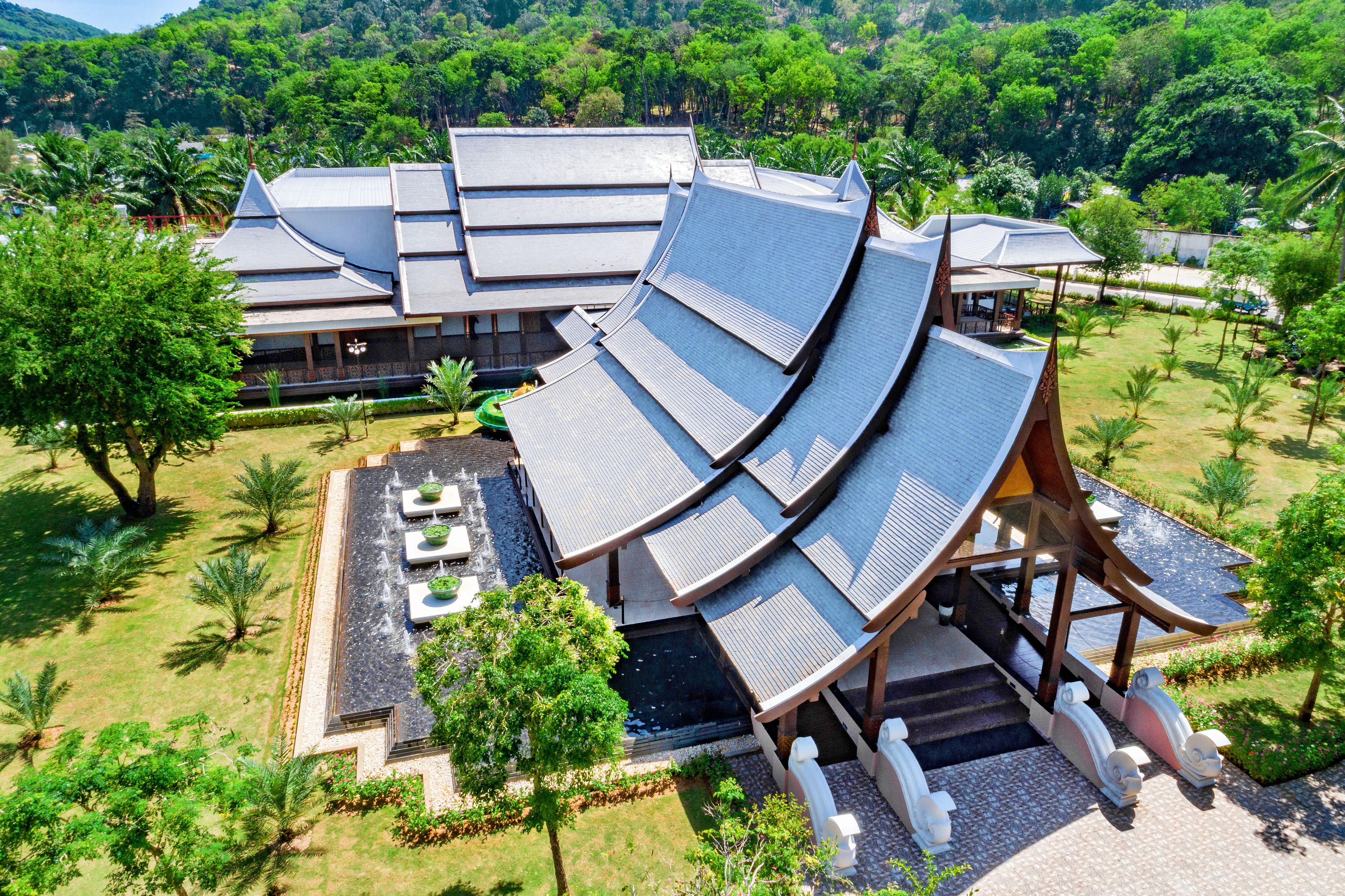 A traditional-style building with curved roofs and a landscaped garden.