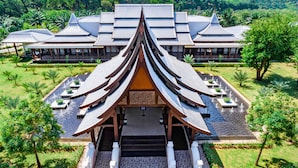 A traditional building with a symmetrical roof and a central entrance with steps. - Duangjitt Resort, Phuket (Patong)