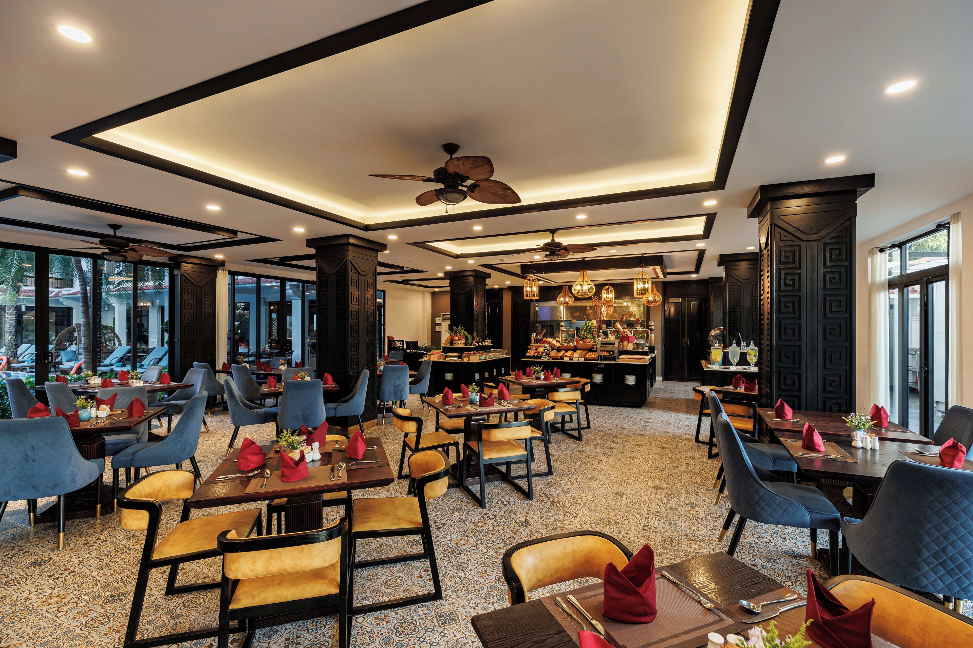 A restaurant with multiple tables and chairs, a bar area, and a ceiling fan.