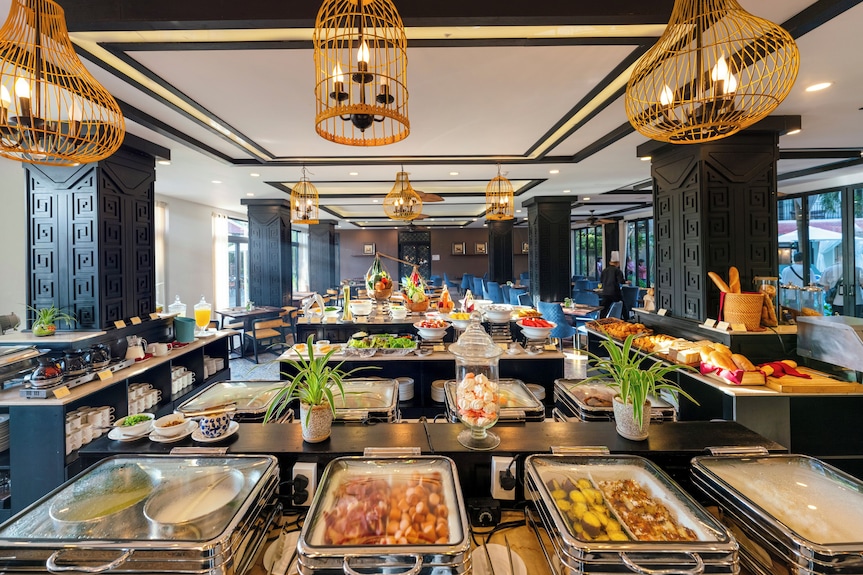 Rice Restaurant mang phong cách hiện đại kết hợp nội thất gỗ ấm áp, phục vụ buffet sáng cùng các món Việt Nam, châu Á, phương Tây và đặc sản Hội An