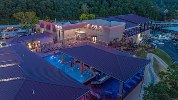 A hotel with a swimming pool, outdoor seating, and a restaurant named "The Encore."