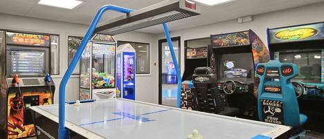 A room with a foosball table, arcade games, and a Target Terror sign.
