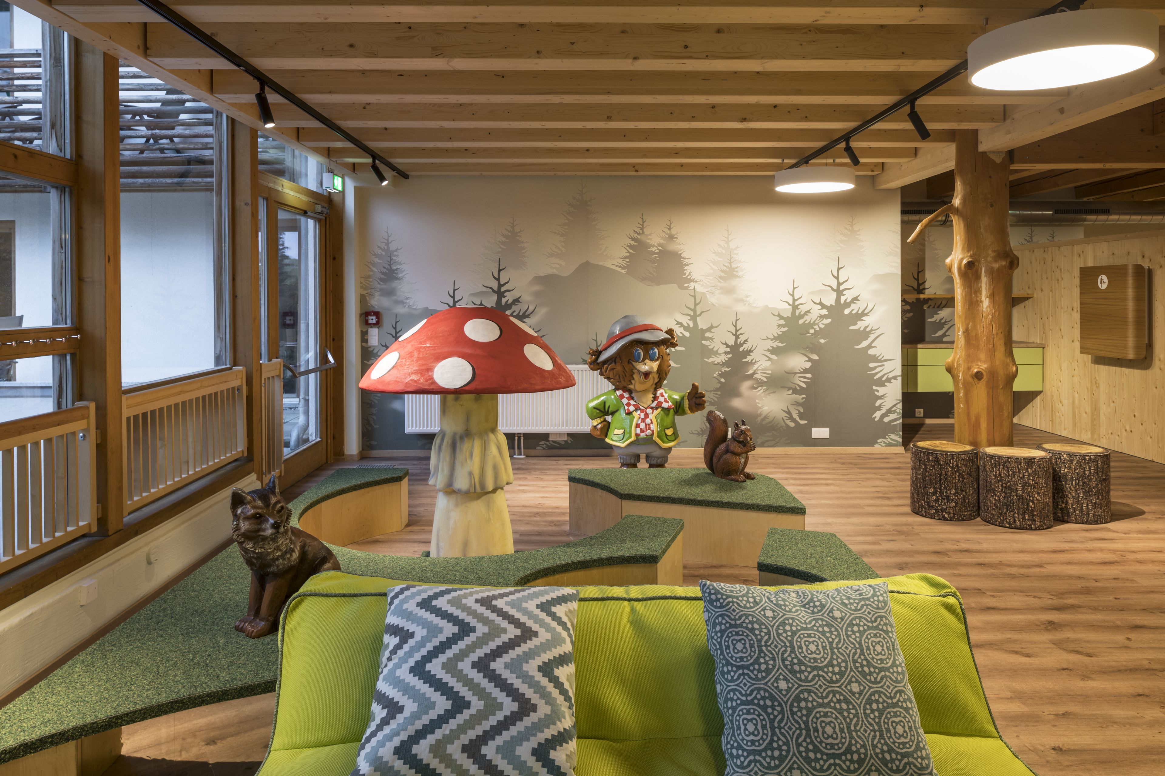 A cozy indoor space with wooden furniture, a large mushroom decoration, and a squirrel figure.