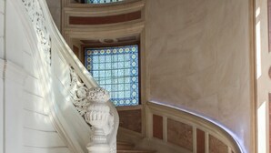 A grand staircase with ornate white balustrades and a patterned floor. - Château Sainte Sabine (Sainte-Sabine)