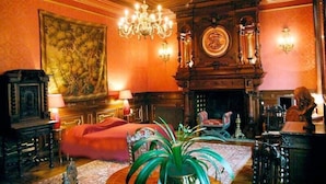 A richly decorated room with a large painting, a chandelier, a fireplace, and ornate furniture. - Domaine de Moresville (Flacey)