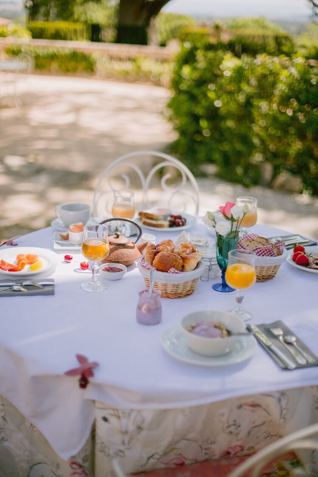 A table set for breakfast with various food items and drinks.