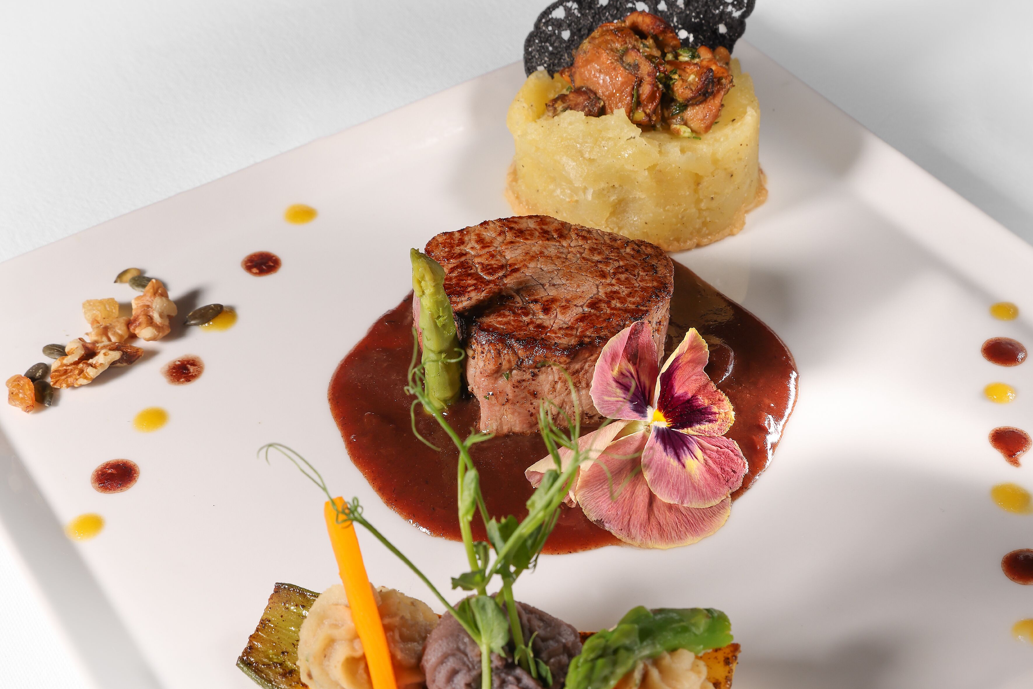 A plated dish with various food items and garnishes.