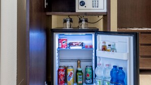 A compact refrigerator with a built-in minibar, containing various beverages and snacks. - Hotel Stadio (Piacenza)