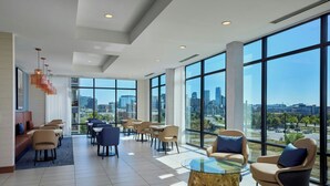A spacious lobby with a city view, modern furniture, and large windows. - Fairfield Inn & Suites by Marriott Denver Downtown (Denver)