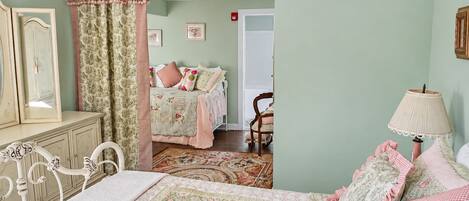 Un dormitorio con cama, cómoda, espejo y una silla.