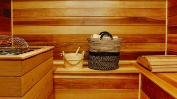 A wooden sauna with a woven basket, a wooden bucket, and a wooden bench.