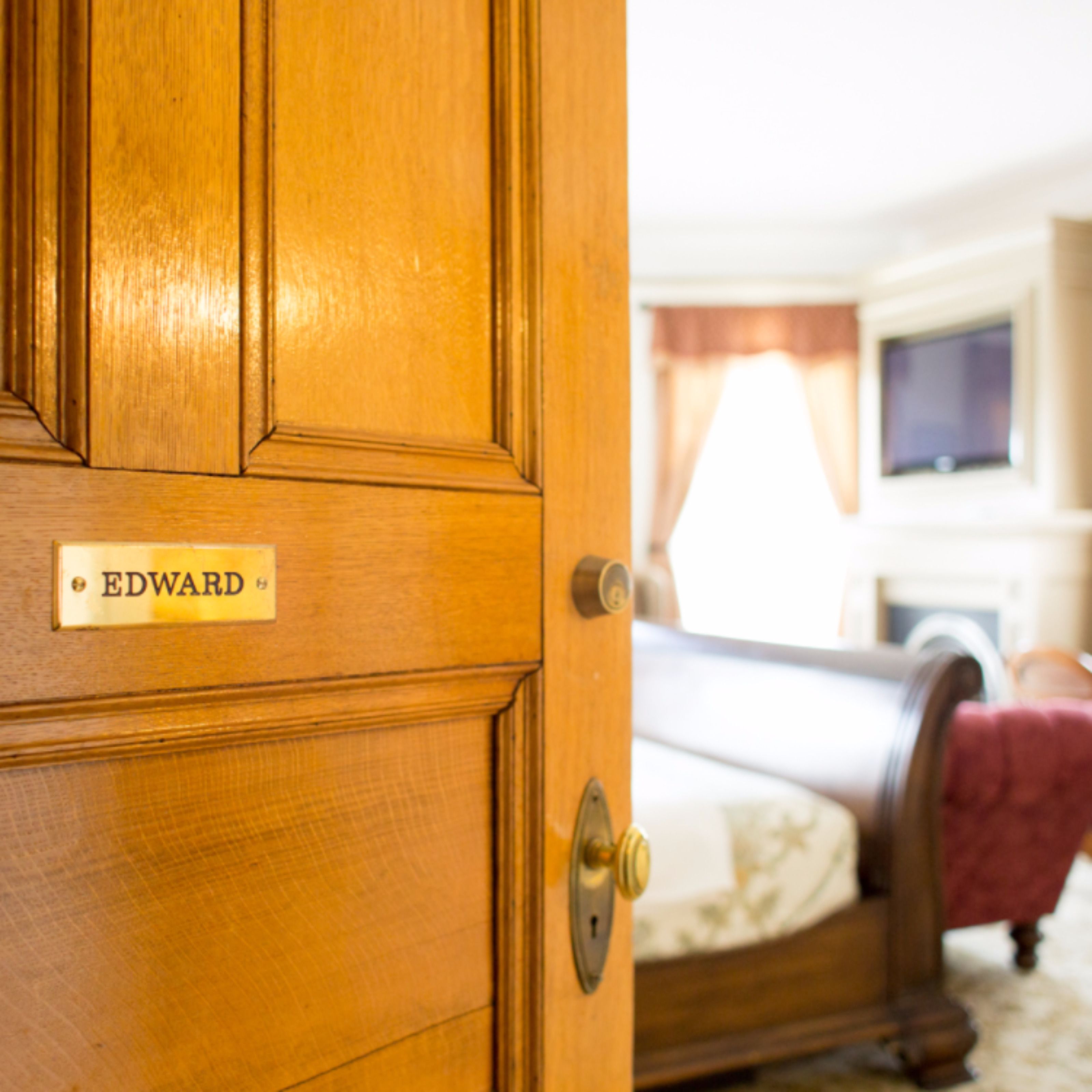 A wooden door with a nameplate reading "EDWARD".
