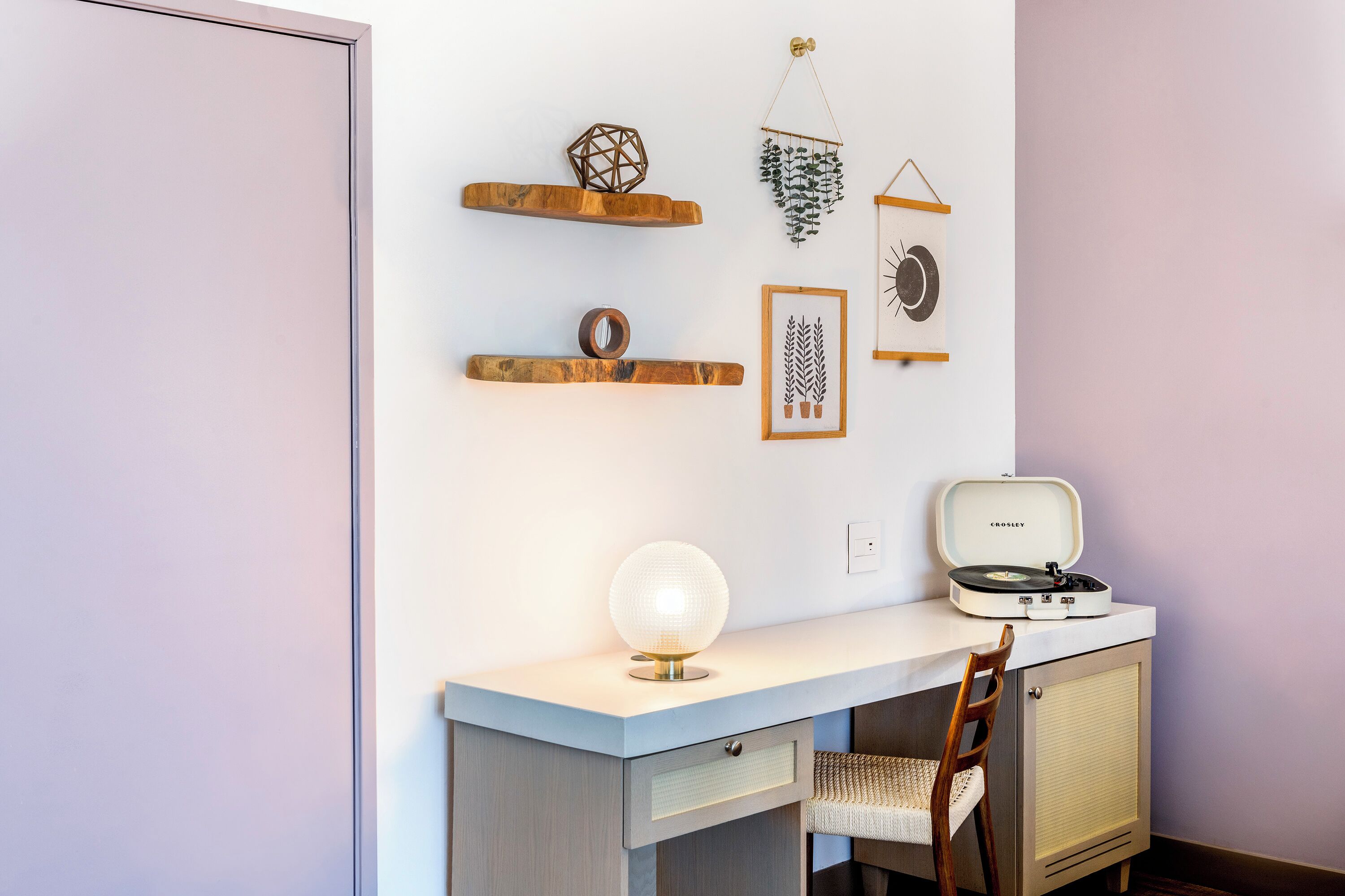 A room with a desk, chair, and a vintage record player.