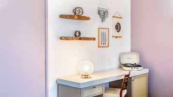 A room with a desk, chair, and a vintage record player.