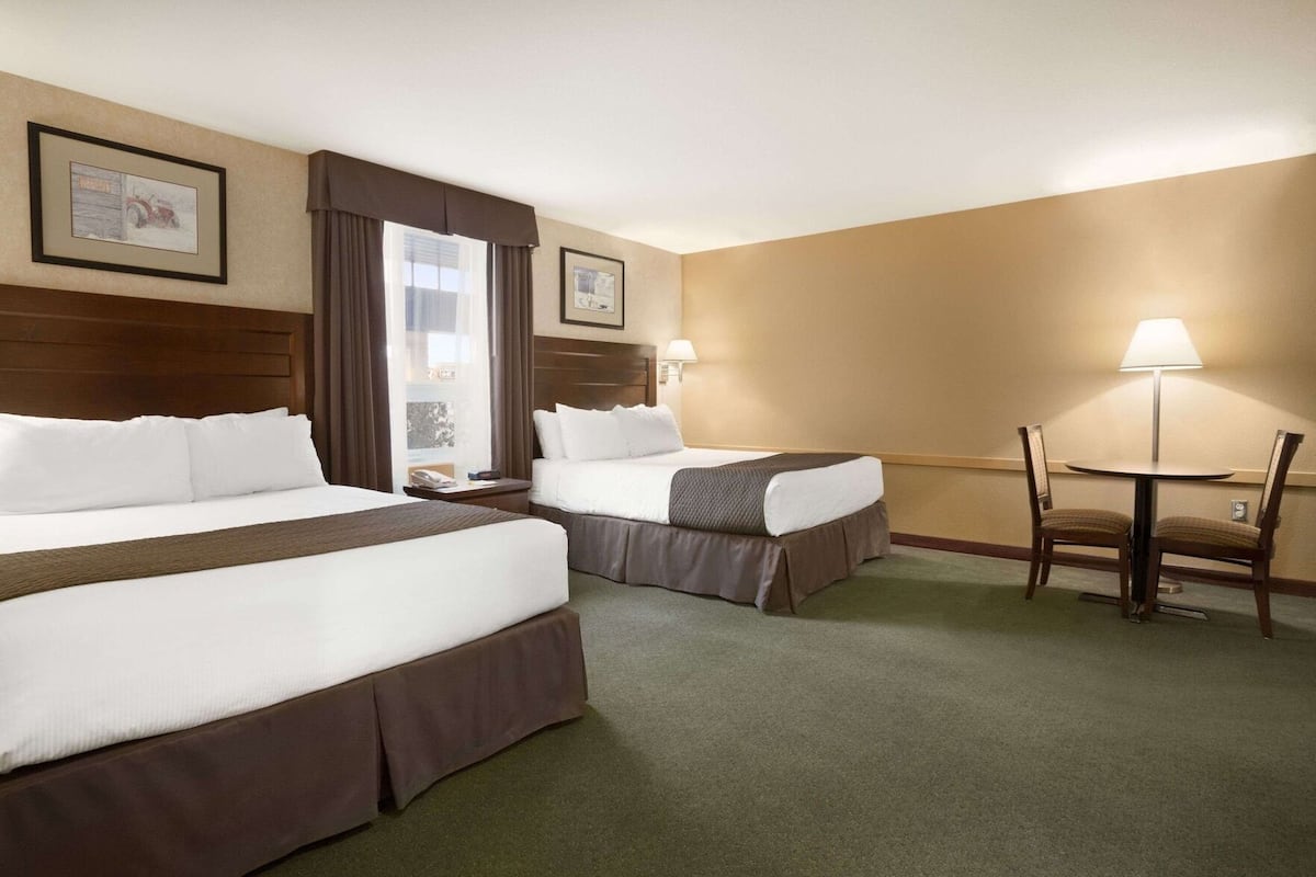 Premium bedding, desk, laptop workspace, blackout drapes