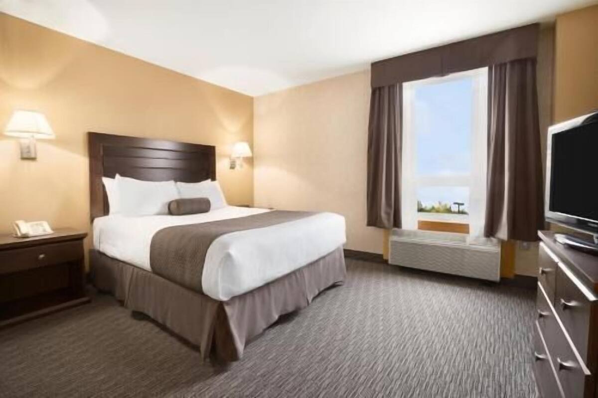 Premium bedding, desk, laptop workspace, blackout drapes