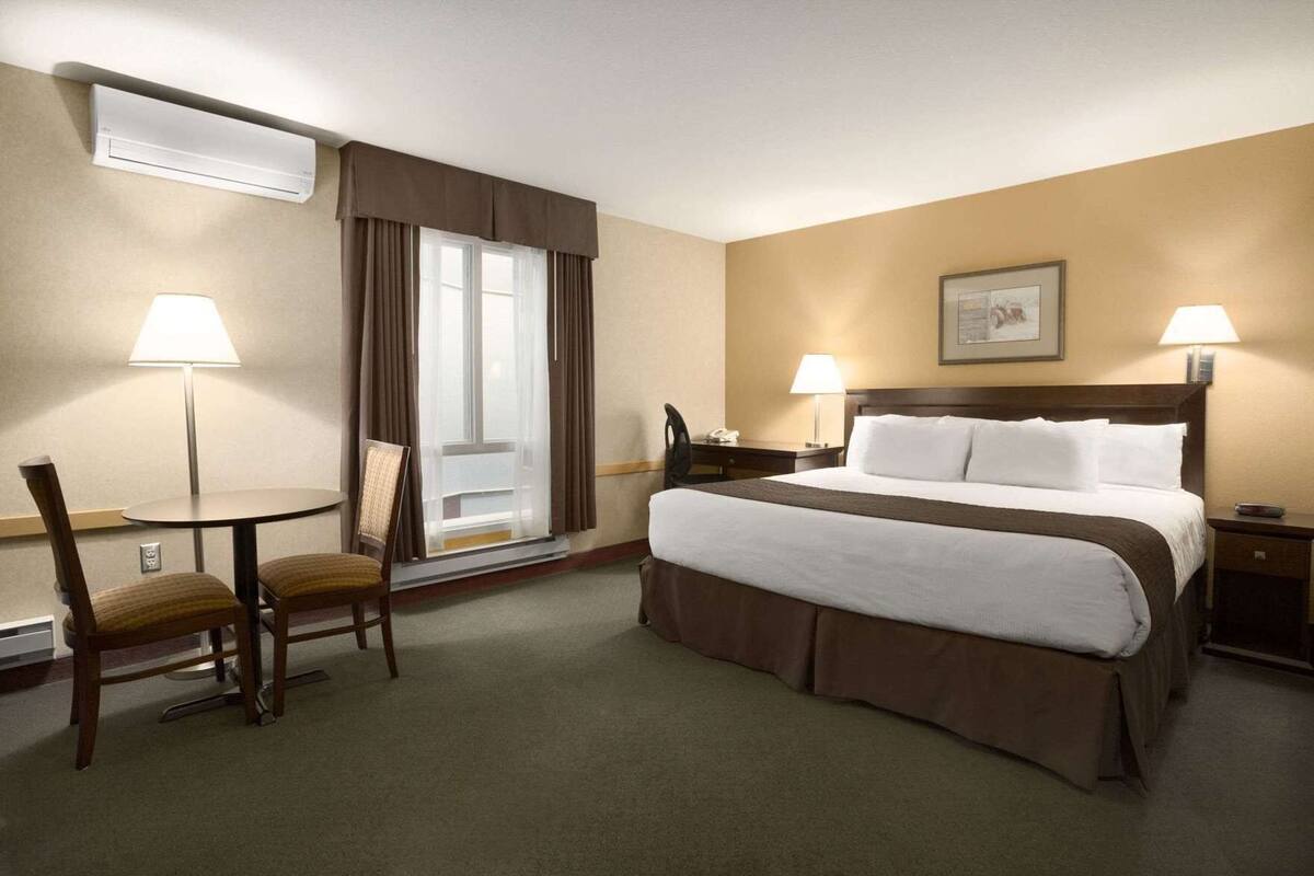 Premium bedding, desk, laptop workspace, blackout drapes