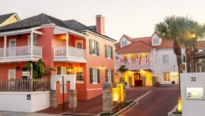 A hotel with a red facade, white balconies, and a sign reading "Hilton." - Hilton St. Augustine Historic Bayfront (St. Augustine)