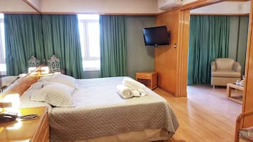 Executive Suite | Premium bedding, minibar, in-room safe, individually decorated