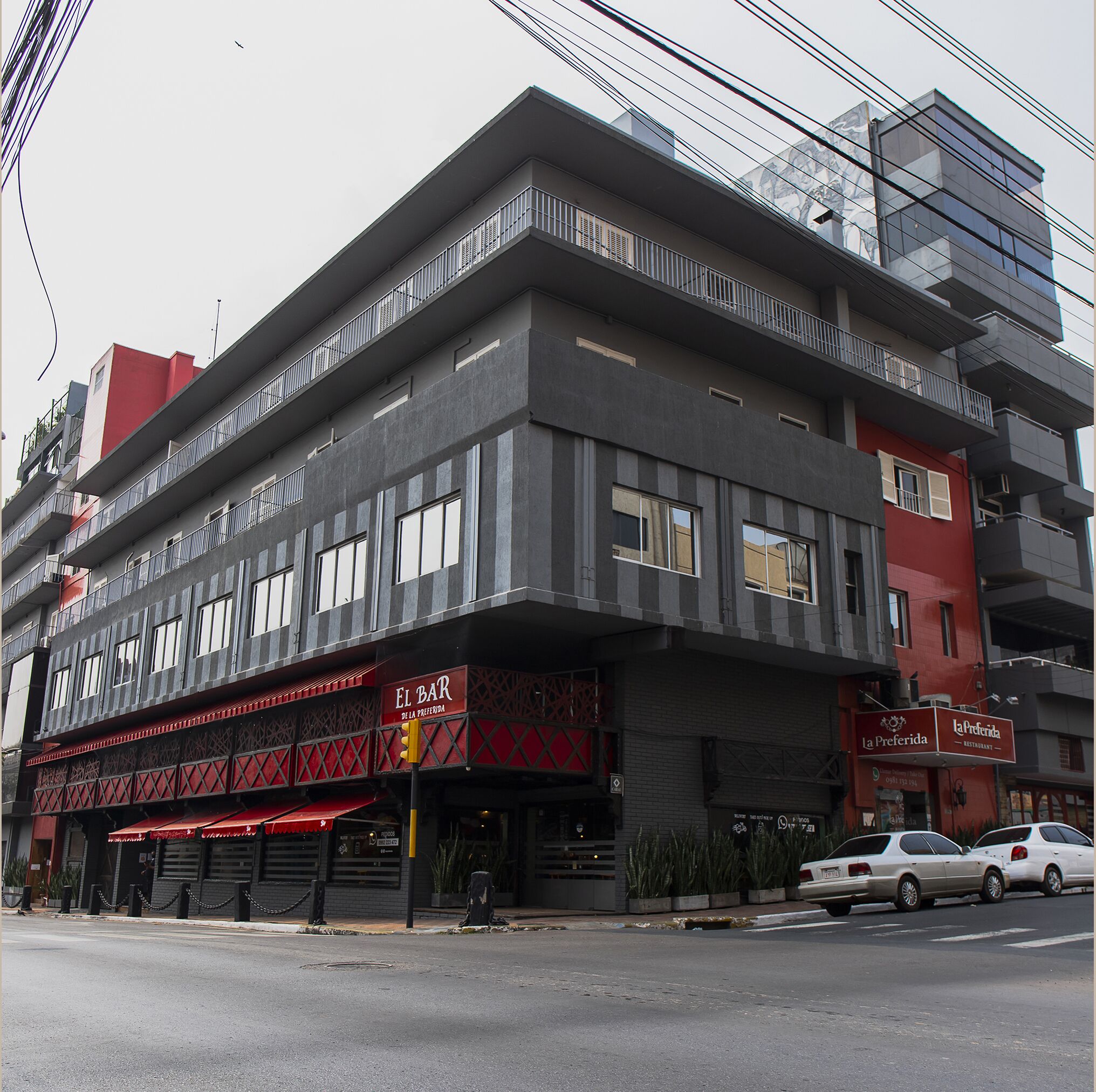 A multi-story building with a ground-level restaurant named "El Bar de la Preferida."